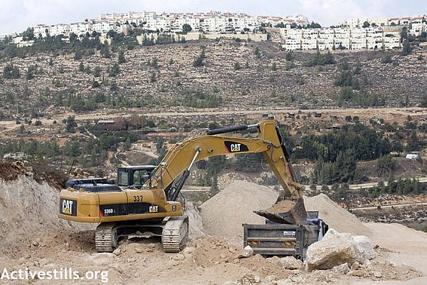 Construction on a road ostensibly connecting the Cremisan Monastery to Jerusalem threatens to uproot olive trees belonging to Hisham Abu Ali and other residents of al-Walaja, West Bank. (Anne Paq/Activestills.org)