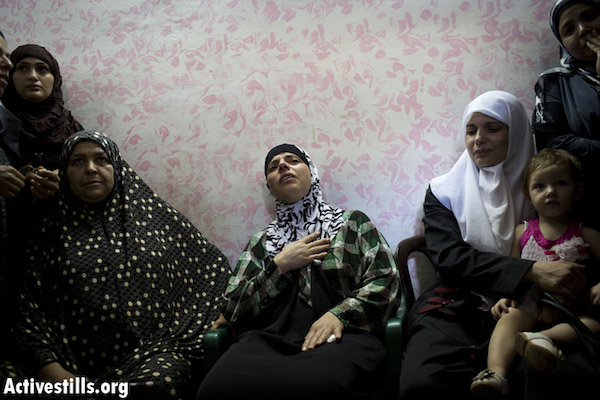 A Palestinian woman mourns the loss of a loved one, who was killed by the Israeli army in Qalandiya Refugee Camp on August, 26, 2013. See below for more details. (Photo: Oren Ziv/Activestills.org)