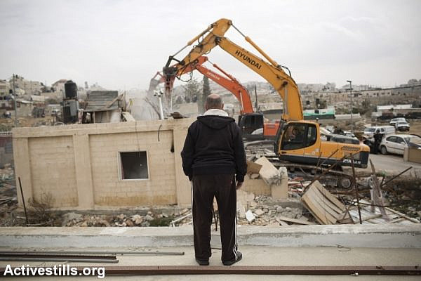 The home of the Palestinian Adgluni family is demolished by Israeli authorities, East Jerusalem, January 27, 2014. Israeli authorities claimed the house was built on lands that do not belong to the family. (Tali Mayer/Activestills.org)
