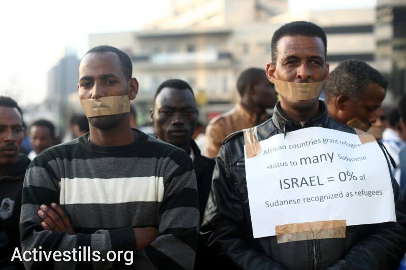 African asylum seekers participate in a silent demonstration in front of the African Union office in Tel Aviv, calling for international support in their struggle for recognition as refugees, January 22, 2014. (photo: Oren Ziv, Yotam Ronen/Activestills.org)