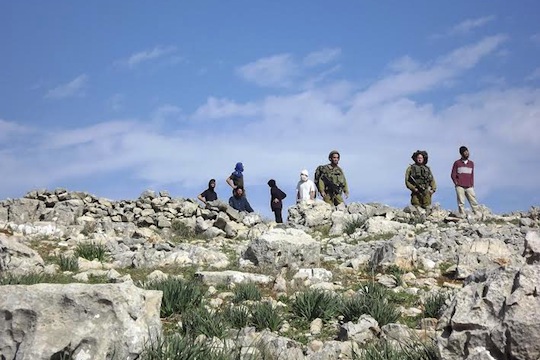 WATCH: Settlers hurl rocks at Palestinians in the presence of IDF soldiers