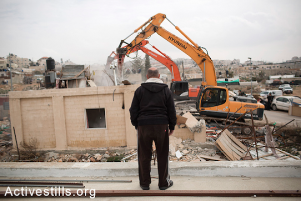 Israeli authorities demolish the Adgluni family home in East Jerusalem, January 27, 2014. (Tali Mayer/Activestills.org) Authorities claim the house was built on lands that do not belong to the family.