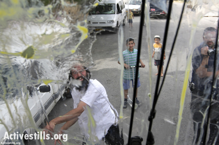 Israeli settlers attack a Palestinian home in Hebron, April 25, 2008.