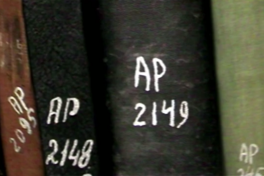 "Palestinian-owned books at Israel's National Library, marked 'AP' for 'abandoned property. (Screenshot from 'The Great Book Robbery')