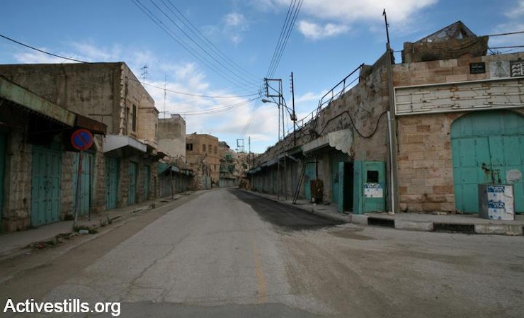 Shuttered shops on Hebron's Shuhada Street. (Photo by Keren Manor/Activestills.org)
