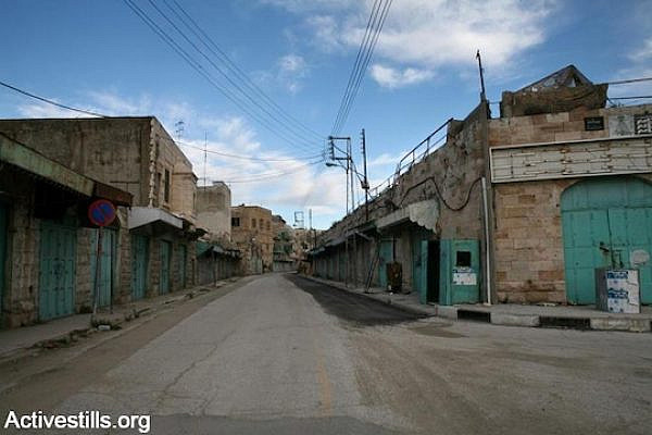Shuttered shops on Hebron's Shuhada Street. (Photo by Keren Manor/Activestills.org)