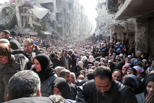 Yarmouk residents gathered to await a food distribution from UNRWA in January 2014. (Photo by UNRWA)