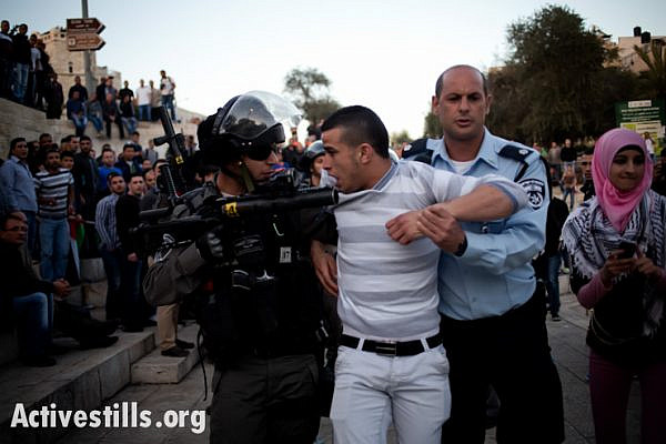 A Palestinian protester arrested by Israeli border police during clashes at Damascus Gate, during a solidarity protest with Jenin Refugee Camp, East Jeruslaem, on March 22, 2014. Dozens of Palestinians protested in Jerusalem against the killing of three Palestinians in Jenin refugee camp. Six protesters were arrested.