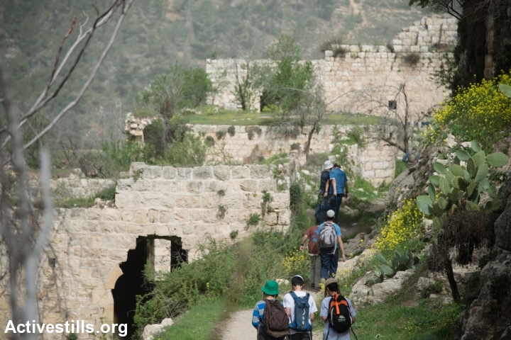 A group of Jewish boys visit the depopulated Palestinian village of Lifta, located on the edge of West Jerusalem, Israel, March 4, 2014. During the Nakba, the residents of Lifta fled attacks by Zionist militias beginning in December 1947, resulting in the complete evacuation of the village by February 1948. (Photo by Ryan Rodrick Beiler/Activestills.org)
