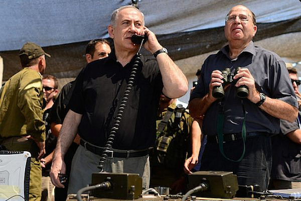 Israeli Prime Minister Benjamin Netanyahu and Defense Minister Moshe Ya’alon survey a military exercise. (Photo by GPO/Kobi Gideon)