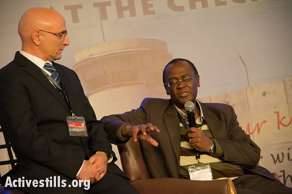 Oded Shoshani, pastor of the Hebrew congregation of King of Kings in Jerusalem, listens as Moss Ntha, General Secretary of the Evangelical Alliance in South Africa, speaks at the Christ at the Checkpoint conference in the West Bank town of Bethlehem, March 13, 2014. (photo: Ryan Rodrick Beiler/Activestills.org)