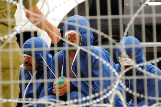 Illustrative photo of Palestinian prisoners in an Israeli military prison (By ChameleonsEye / Shutterstock.com)