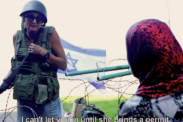 An Israeli woman acts out the role of a soldier at a Gazan checkpoint. (YouTube screenshot)