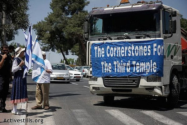 A Jewish group called "Temple Mount and Land of Israel faithful movement" walks through Jerusalem on 21.05.2009. They are followed by a truck which carried stones to be "the cornerstones of the Third temple.” (Photo by: Anne Paq/Activestills.org)
