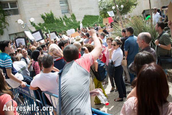 A heckler shouts at demonstrators protesting against Israeli government attempts to recruit Palestinian Christian citizens of Israel, May 7, 2014. (photo: Ryan Rodrick Beiler/Activestills.org)