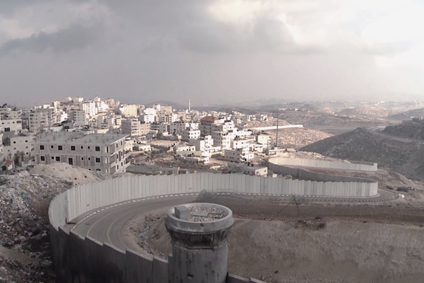 Israel's separation barrier surrounds a Palestinian neighborhood of East Jerusalem. (Screenshot from '3 Houses')