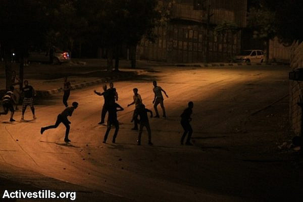 Clashes erupt after the Israeli army raided Balata Refugee Camp and several neighborhoods in Nablus, West Bank, June 27, 2014. (Photo by Ahmad Al-Bazz/Activestills.org)