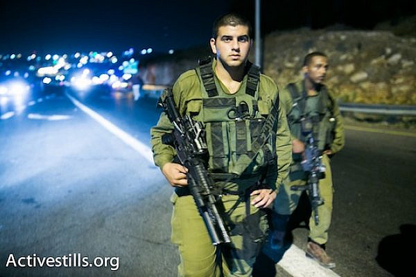 Israeli soldiers near the Palestinian city of Halhul, where the bodies of the three kidnapped Israeli teenagers were found. (photo: Activestills)