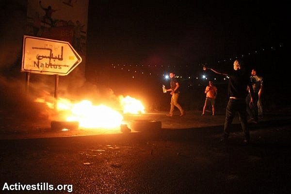 Clashes erupted between hundreds of Palestinians and the Israeli army during a demonstration in Solidarity with the Gaza Strip at Huwwara military checkpoint, Nablus, West Bank in the early morning of July 24, 2014. (photo: Activestills)