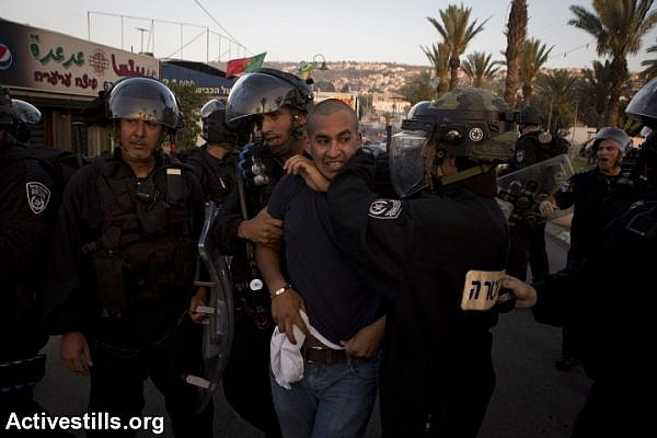 Israeli policemen arrest a Palestinian protestor during clashes in Arara, in Israel's north, in the wake of the murder of 16-year-old Muhammad Abu Khdeir. (photo: Activestills.org)