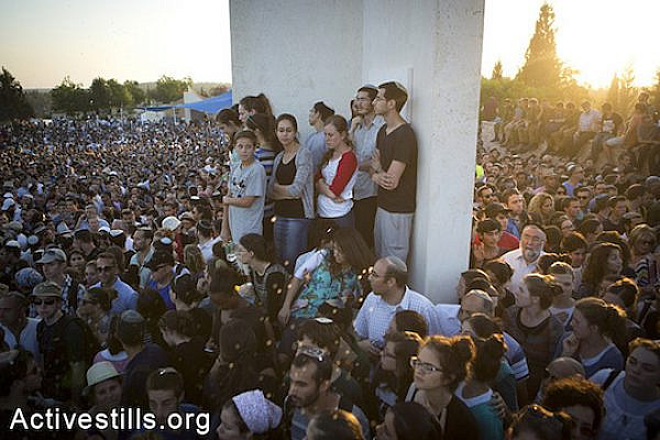 Family and friends of Eyal Yifrah, Gilad Shaar, and Naftali Fraenkel, three Israeli teenagers who were abducted over two weeks ago, take part in their funeral in the city of Modiin, Israel, Tuesday, July 1, 2014. (Oren Ziv/Activestills.org)