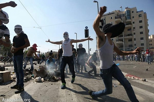 Palestinian youth throw rocks at Israeli security forces during clashes in Shuafat. The clashes erupted during the funeral for Muhammad Abu Khdeir, a 16-year-old Palestinian who was suspected of being murdered by Jewish nationalists in Jerusalem. (photo: Oren Ziv/Activestills.org)