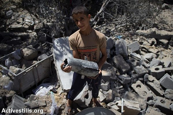 A young Gazan holds the remains of an Israeli missile. (photo: Anne Paq/Activestills.org)