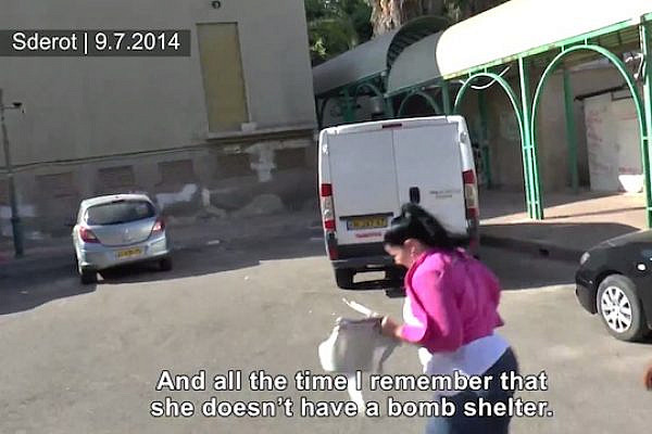 An Israeli woman runs for shelter in Sderot, July 9, 2014. (Social TV)
