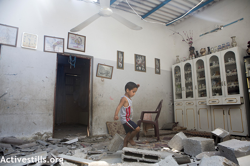 A child amidst the rubble of his home, which had been destroyed the night before in Gaza. (photo: Anne Paq/Activestills)