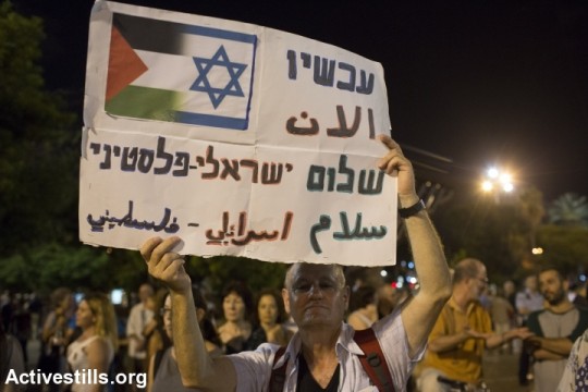 Israelis take part in a protest calling for peace negotiations between Israel and Palestinian, Tel Aviv, on August 16, 2014. Thousands of demonstrators gathered on Saturday for a pro-peace rally under the slogan: 'Changing Direction: Toward Peace, Away From War.' (photo: Activestills)