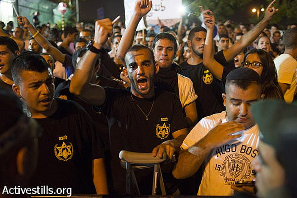 Right-wing Lehava activists shout slogans as they protest outside the wedding hall where Mahmoud Mansour, a Palestinian Israeli, and Morel Malcha, a Jewish Israeli, got married on August 17, 2014 in Rishon Letzion. Police arrested at least 7 right wing protesters, out of over 300 who were protesting against the wedding. (Oren Ziv/Activestills.org)