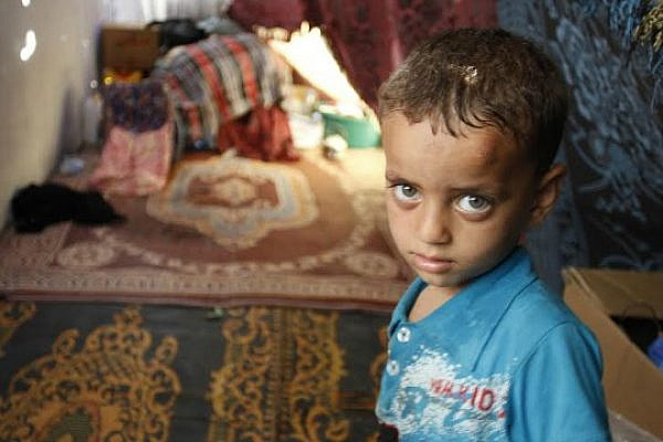 Three-year-old Firas Farhat lives with his brother, father and mother in a makeshift tent on a sidewalk outside Shifa Hospital. Their home in Gaza's Shejaiya neighborhood was destroyed by Israeli shelling. (photo: Samer Badawi)