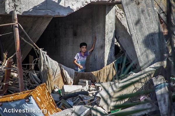 A Palestinian child stands in a destroyed house in the Shujayea neighborhood, which was heavily attacked during the latest Israeli offensive, east of Gaza City, September 4, 2014. During the seven-week Israeli military offensive, 2,101 Palestinians were killed, including 495 children, and an estimated 18,000 housing units have been either destroyed or severely damaged, leaving more than 108,000 people homeless.