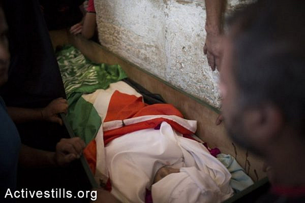 Muhammad Sunuqrut's body is prepared for the funeral procession, East Jerusalem, September 8, 2014. (Photo: Oren Ziv/Activestills.org)
