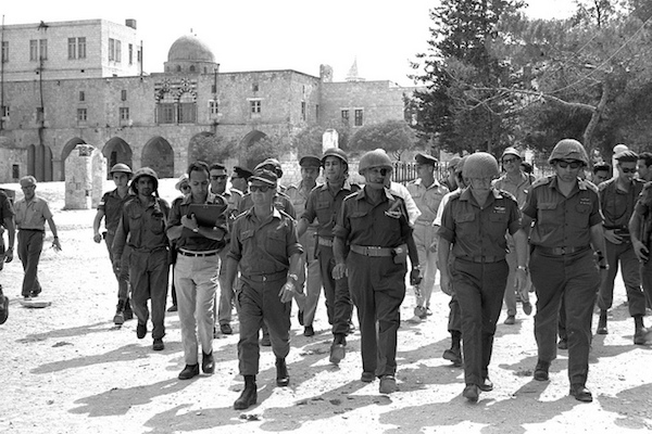 Israeli Defense Minister Moshe Dayan, Chief of Staff Yitzhak Rabin, Gen. Rehavam Ze’evi (right) and Gen. Uzi Narkiss walk through the Old City of Jerusalem on June 7, 1967, during the Six Day War. (Photo by GPO/Ilan Bruner)