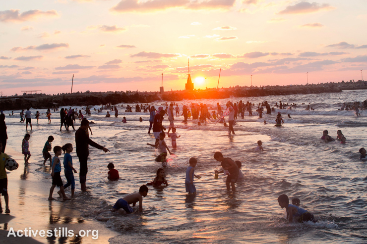 Palestinians gather at the beach at sunset in Al Meena, Gaza City, September 12, 2014. After seven weeks of Israeli offensive, during which most Palestinians were confined to their homes, many Palestinians went to the beach to enjoy some open space.