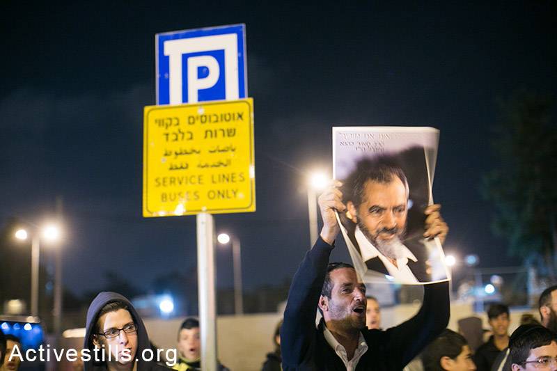 Israeli right-wing protesters chant slogans and holding signs calling for revenge, during a protest near the tram station in East Jerusalem, a day after a Palestinian driver ran over the crowded area, East Jerusalem, October 23, 2014. The attack saw a Palestinian ramming his car at high speed, killing a baby and injuring another six people. (Activestills.org)