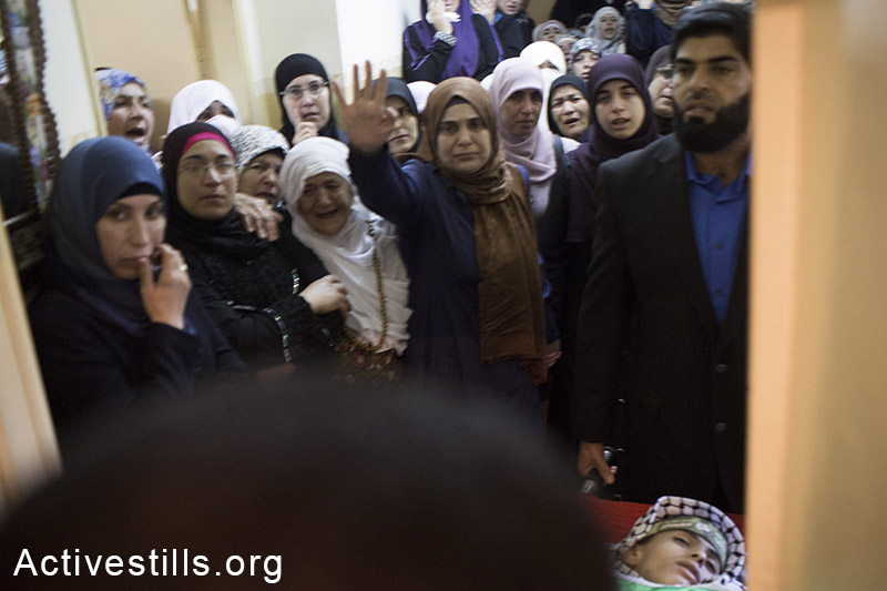 Palestinians carry the body of Orwa Hammad, a 14-year old, at his funeral in the West Bank village of Silwad, October 26, 2014. Israeli soldiers shot and killed Hammad, which was an American citizen, during clashes in his village on October 24, 2014. (Activestills.org)