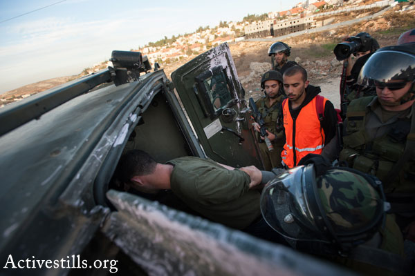 Illustrative photo of Israeli soldiers arresting a Palestinian man (Activestills.org)