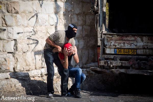 Illustrative photo of masked undercover Israeli police arresting a Palestinian (Activestills.org)