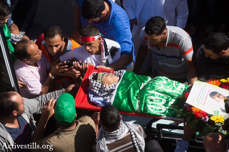 Mourners carry the body of 14-year-old Palestinian-American Orwah Hammad at his funeral in the West Bank village of Silwad, October 26, 2014. (Photo by Oren Ziv/Activestills.org)