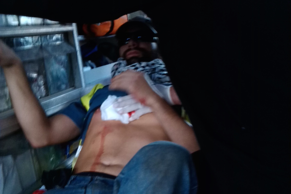 Italian ISM activist Patrick Corsi in an ambulance after being shot in the chest by Israeli forces, November 28, 2014. (Photo courtesy of ISM)