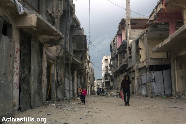 Palestinians walk through the Shujayea neighborhood of Gaza City, nearly three months since a cease fire ended Operation Protective Edge, November 16, 2014. (Photo by Anne Paq/Activestills.org)
