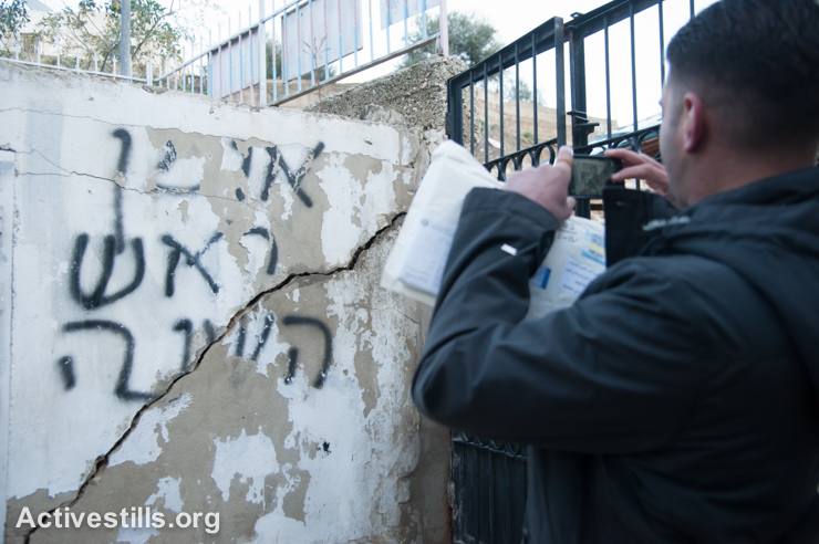Silwan resident Daoud Al-Ghoul documents damage to Palestinian property due to excavations by the settler archeology group Elad, East Jerusalem, December 16, 2013.