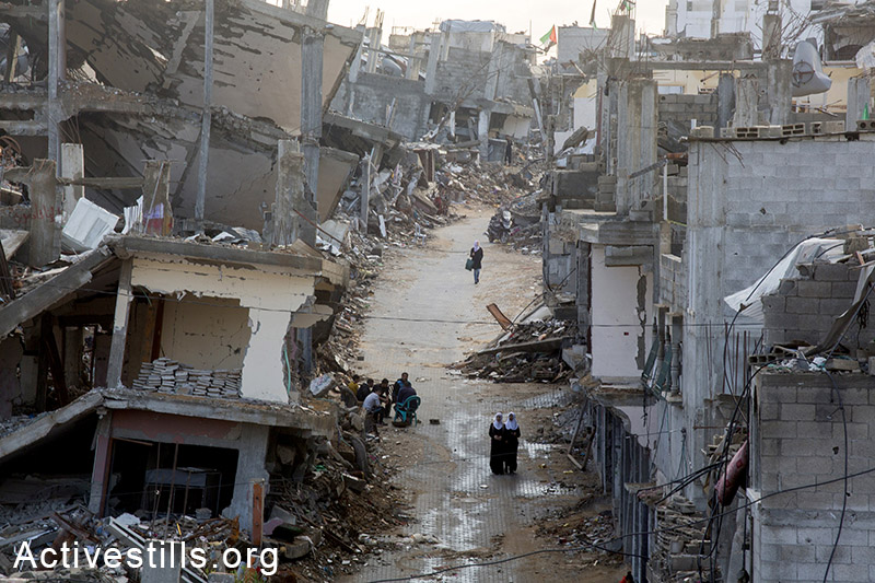Palestinian school girls walk across a destroyed part of Shujayea neighborood, Gaza city, November 4th, 2014. Many Palestinians in the Gaza Strip face hard living conditions following the seven-week Israeli offensive during which 2,131 Palestinians were killed, and an estimate of 18,000 housing units have been either destroyed or severely damaged, leaving more than 108,000 people homeless. By: Anne Paq/Activestills.org