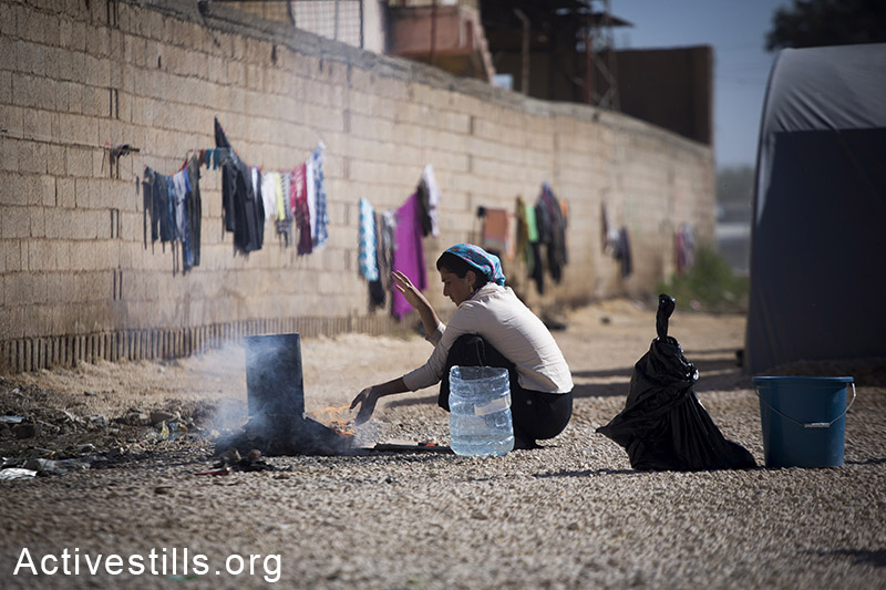 A woman cooking at the Ravaya refugee camp in the city of Suruc, Turkey, October 2014. Photo: Faiz Abu-Rmeleh/Activestills.org