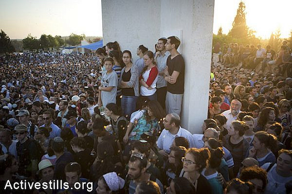 Family and friends of Eyal Yifrah, Gilad Shaar, and Naftali Fraenkel, three Israeli teenagers who were abducted and killed in the West Bank, take part in their funeral in the city of Modi’in, Israel, Tuesday, July 1, 2014. (Oren Ziv/Activestills.org)