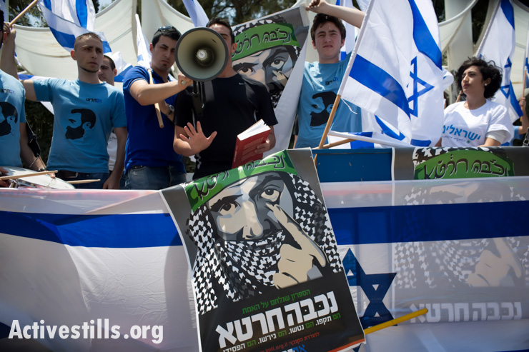 Right-wing nationalists from the quasi-fascist group, Im Tirzu, protest as Palestinian citizens of Israel and their Jewish-Israeli supporters commemorate the Nakba at Tel Aviv University, May 11, 2014. (Activestills.org)