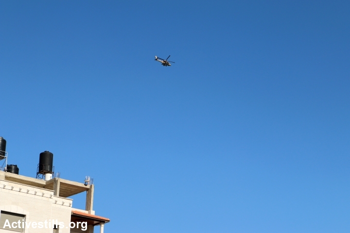 Israeli helicopters seen over the village of Burin during the funeral of Ahmed Najjar, West Bank, February 1st, 2015. (photo by: Ahmad al-Bazz/Activestills.org)