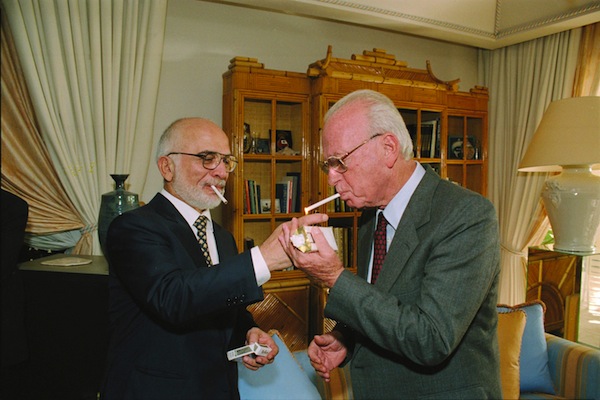 King Hussein of Jordan lights Prime Minister Yitzhak Rabin's cigarette at the Royal Residence in Aqaba, Jordan, shortly after signing the peace treaty at the Arava Border Crossing. (photo: GPO)